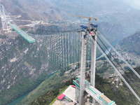 The Huajiang Canyon Bridge is under construction in Qianxinan, Guizhou province, China, on November 30, 2024. The bridge is a steel girder s...