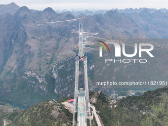 The Huajiang Canyon Bridge is under construction in Qianxinan, Guizhou province, China, on November 30, 2024. The bridge is a steel girder s...