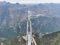 The Huajiang Canyon Bridge is under construction in Qianxinan, Guizhou province, China, on November 30, 2024. The bridge is a steel girder s...