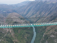 The Huajiang Canyon Bridge is under construction in Qianxinan, Guizhou province, China, on November 30, 2024. The bridge is a steel girder s...