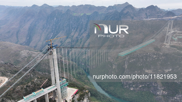 The Huajiang Canyon Bridge is under construction in Qianxinan, Guizhou province, China, on November 30, 2024. The bridge is a steel girder s...