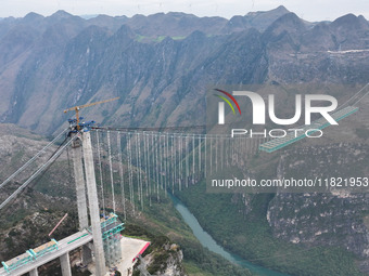 The Huajiang Canyon Bridge is under construction in Qianxinan, Guizhou province, China, on November 30, 2024. The bridge is a steel girder s...