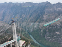 The Huajiang Canyon Bridge is under construction in Qianxinan, Guizhou province, China, on November 30, 2024. The bridge is a steel girder s...