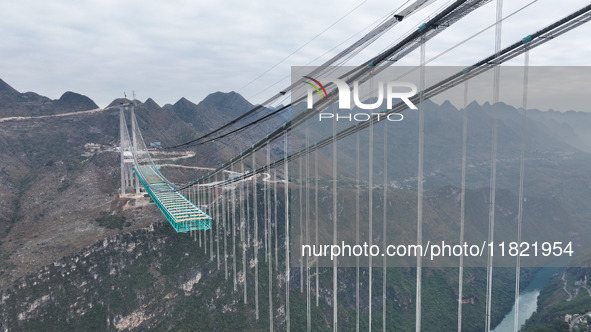 The Huajiang Canyon Bridge is under construction in Qianxinan, Guizhou province, China, on November 30, 2024. The bridge is a steel girder s...