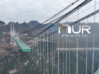 The Huajiang Canyon Bridge is under construction in Qianxinan, Guizhou province, China, on November 30, 2024. The bridge is a steel girder s...