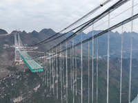 The Huajiang Canyon Bridge is under construction in Qianxinan, Guizhou province, China, on November 30, 2024. The bridge is a steel girder s...