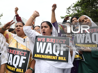 Activists from The All India Trinamool Congress take part in a protest meeting in Kolkata, India, on November 30, 2024, demanding the withdr...