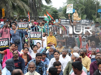 Activists from The All India Trinamool Congress take part in a protest meeting in Kolkata, India, on November 30, 2024, demanding the withdr...