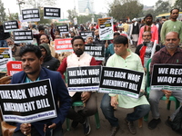 Activists from The All India Trinamool Congress take part in a protest meeting in Kolkata, India, on November 30, 2024, demanding the withdr...