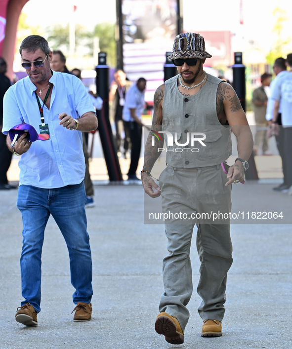 The British Formula One driver Lando Norris of McLaren walks through the paddock as he arrives ahead of the Formula 1 Grand Prix of Qatar at...