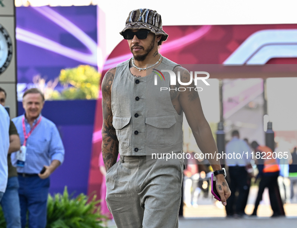 The British Formula One driver Lando Norris of McLaren walks through the paddock as he arrives ahead of the Formula 1 Grand Prix of Qatar at...