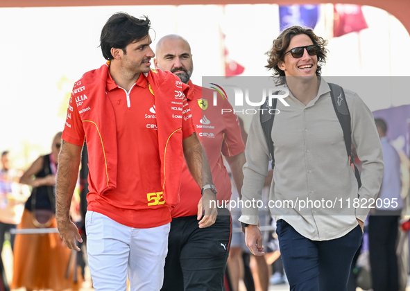 Spanish Formula One driver Carlos Sainz of Ferrari walks through the paddock as he arrives ahead of the Formula 1 Grand Prix of Qatar at Lus...