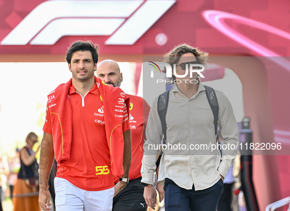 Spanish Formula One driver Carlos Sainz of Ferrari walks through the paddock as he arrives ahead of the Formula 1 Grand Prix of Qatar at Lus...