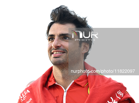 Spanish Formula One driver Carlos Sainz of Ferrari walks through the paddock as he arrives ahead of the Formula 1 Grand Prix of Qatar at Lus...