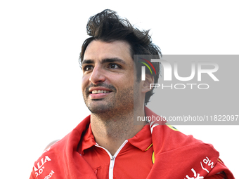 Spanish Formula One driver Carlos Sainz of Ferrari walks through the paddock as he arrives ahead of the Formula 1 Grand Prix of Qatar at Lus...