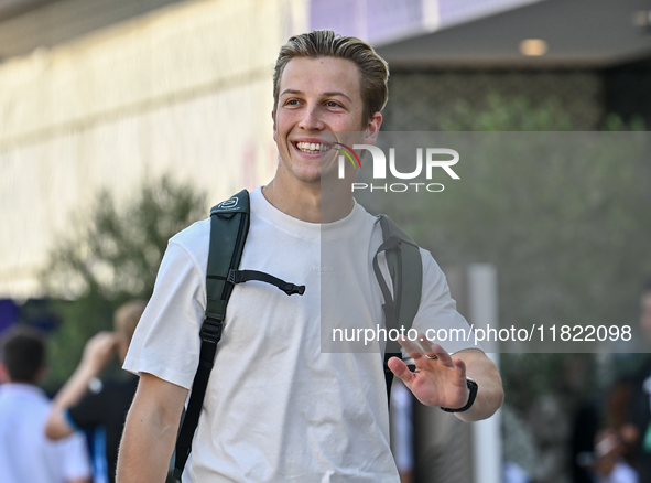 New Zealander Formula One driver Liam Lawson of RB walks through the paddock as he arrives ahead of the Formula 1 Grand Prix of Qatar at Lus...