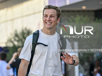 New Zealander Formula One driver Liam Lawson of RB walks through the paddock as he arrives ahead of the Formula 1 Grand Prix of Qatar at Lus...