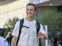 New Zealander Formula One driver Liam Lawson of RB walks through the paddock as he arrives ahead of the Formula 1 Grand Prix of Qatar at Lus...