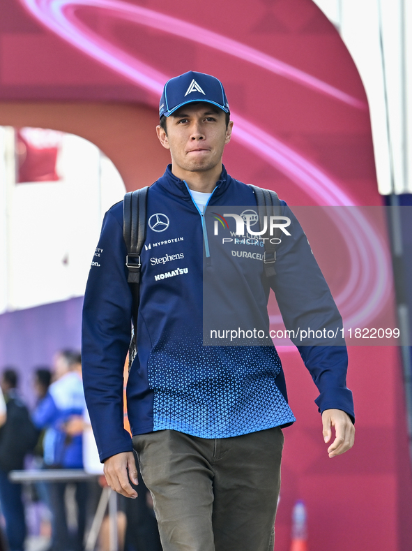 Thai Formula One driver Alexander Albon of Williams walks through the paddock as he arrives ahead of the Formula 1 Grand Prix of Qatar at Lu...