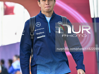 Thai Formula One driver Alexander Albon of Williams walks through the paddock as he arrives ahead of the Formula 1 Grand Prix of Qatar at Lu...