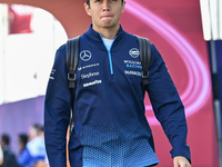 Thai Formula One driver Alexander Albon of Williams walks through the paddock as he arrives ahead of the Formula 1 Grand Prix of Qatar at Lu...