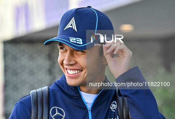 Thai Formula One driver Alexander Albon of Williams walks through the paddock as he arrives ahead of the Formula 1 Grand Prix of Qatar at Lu...