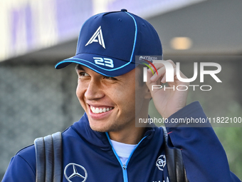 Thai Formula One driver Alexander Albon of Williams walks through the paddock as he arrives ahead of the Formula 1 Grand Prix of Qatar at Lu...