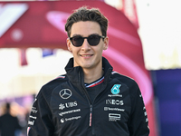 The British Formula One driver George Russell of Mercedes walks through the paddock as he arrives ahead of the Formula 1 Grand Prix of Qatar...