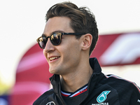 The British Formula One driver George Russell of Mercedes walks through the paddock as he arrives ahead of the Formula 1 Grand Prix of Qatar...