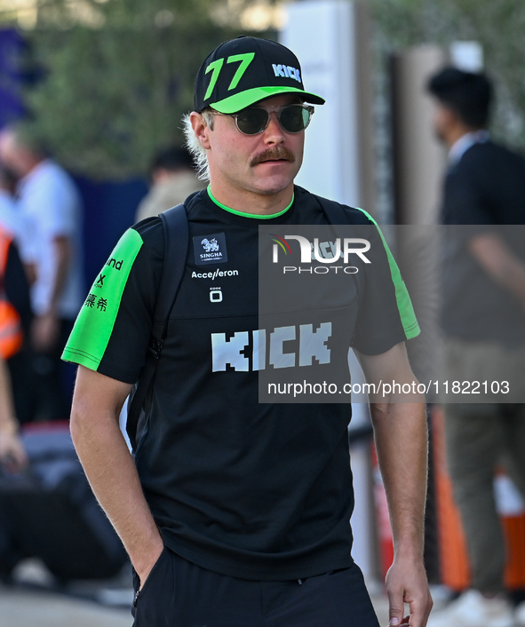 Finnish Formula One driver Valtteri Bottas of Kick Sauber walks through the paddock as he arrives ahead of the Formula 1 Grand Prix of Qatar...