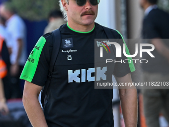 Finnish Formula One driver Valtteri Bottas of Kick Sauber walks through the paddock as he arrives ahead of the Formula 1 Grand Prix of Qatar...