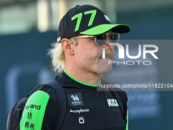 Finnish Formula One driver Valtteri Bottas of Kick Sauber walks through the paddock as he arrives ahead of the Formula 1 Grand Prix of Qatar...