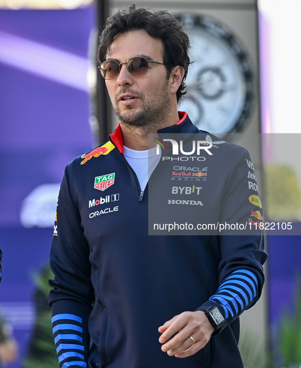 Mexican Formula One driver Sergio Perez of Red Bull Racing walks through the paddock as he arrives ahead of the Formula 1 Grand Prix of Qata...