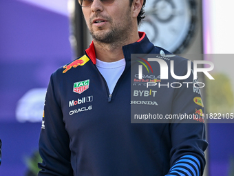 Mexican Formula One driver Sergio Perez of Red Bull Racing walks through the paddock as he arrives ahead of the Formula 1 Grand Prix of Qata...