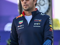 Mexican Formula One driver Sergio Perez of Red Bull Racing walks through the paddock as he arrives ahead of the Formula 1 Grand Prix of Qata...