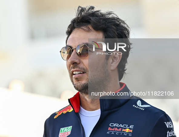 Mexican Formula One driver Sergio Perez of Red Bull Racing walks through the paddock as he arrives ahead of the Formula 1 Grand Prix of Qata...