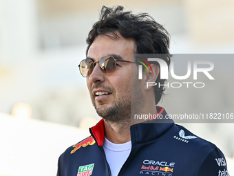 Mexican Formula One driver Sergio Perez of Red Bull Racing walks through the paddock as he arrives ahead of the Formula 1 Grand Prix of Qata...