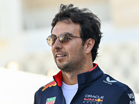 Mexican Formula One driver Sergio Perez of Red Bull Racing walks through the paddock as he arrives ahead of the Formula 1 Grand Prix of Qata...