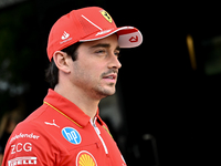 Monaco's Formula One driver Charles Leclerc of Ferrari walks through the paddock as he arrives ahead of the Formula 1 Grand Prix of Qatar at...