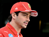 Monaco's Formula One driver Charles Leclerc of Ferrari walks through the paddock as he arrives ahead of the Formula 1 Grand Prix of Qatar at...