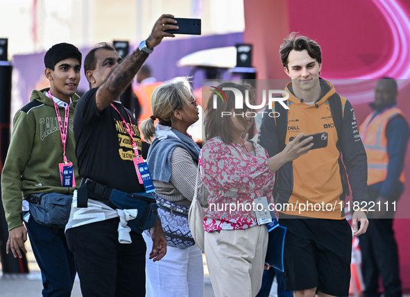 Australian Formula One driver Oscar Piastri of McLaren walks through the paddock as he arrives ahead of the Formula 1 Grand Prix of Qatar at...