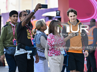 Australian Formula One driver Oscar Piastri of McLaren walks through the paddock as he arrives ahead of the Formula 1 Grand Prix of Qatar at...