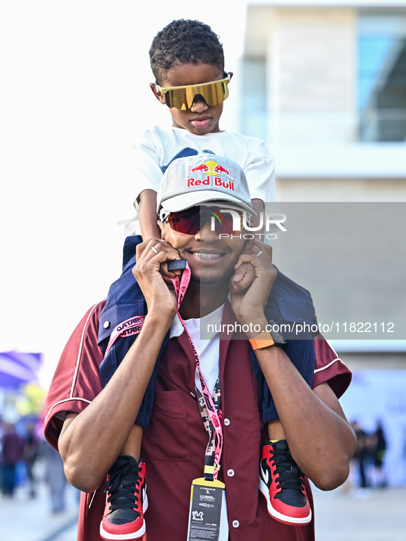 Mutaz Essa Barsham, the Qatari high jump Olympic champion, arrives with his son Yousef ahead of the Formula 1 Grand Prix of Qatar at Lusail...