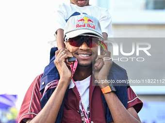 Mutaz Essa Barsham, the Qatari high jump Olympic champion, arrives with his son Yousef ahead of the Formula 1 Grand Prix of Qatar at Lusail...