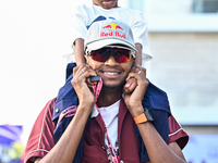 Mutaz Essa Barsham, the Qatari high jump Olympic champion, arrives with his son Yousef ahead of the Formula 1 Grand Prix of Qatar at Lusail...