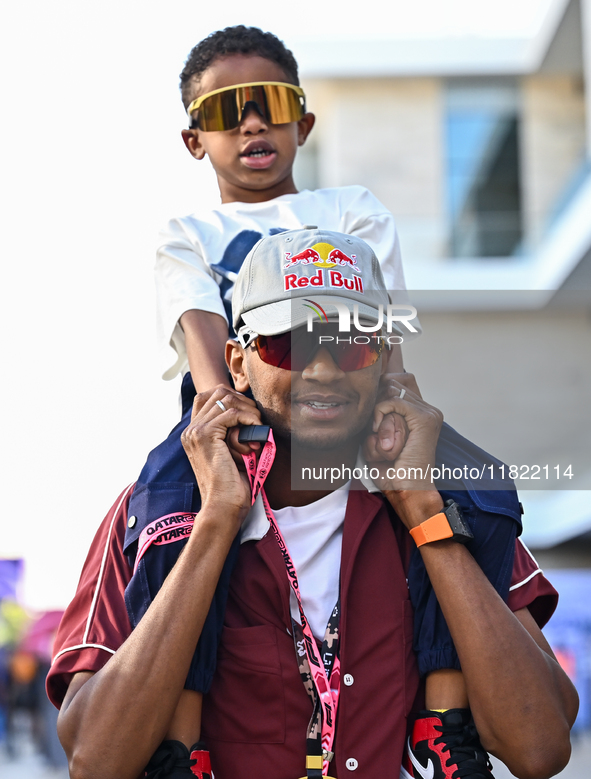 Mutaz Essa Barsham, the Qatari high jump Olympic champion, arrives with his son Yousef ahead of the Formula 1 Grand Prix of Qatar at Lusail...