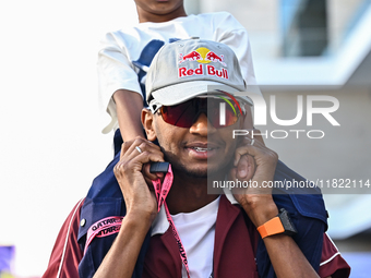 Mutaz Essa Barsham, the Qatari high jump Olympic champion, arrives with his son Yousef ahead of the Formula 1 Grand Prix of Qatar at Lusail...