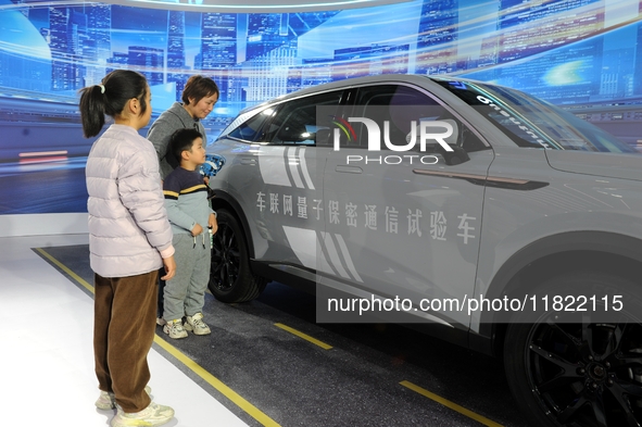 Visitors visit a test vehicle for networked quantum secure communication at the 2024 Quantum Technology and Industry Conference in Hefei, Ch...