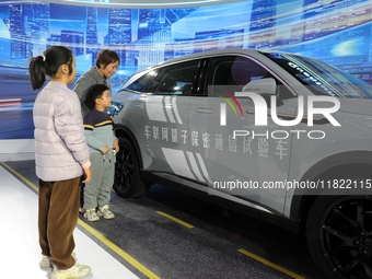 Visitors visit a test vehicle for networked quantum secure communication at the 2024 Quantum Technology and Industry Conference in Hefei, Ch...