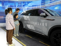 Visitors visit a test vehicle for networked quantum secure communication at the 2024 Quantum Technology and Industry Conference in Hefei, Ch...